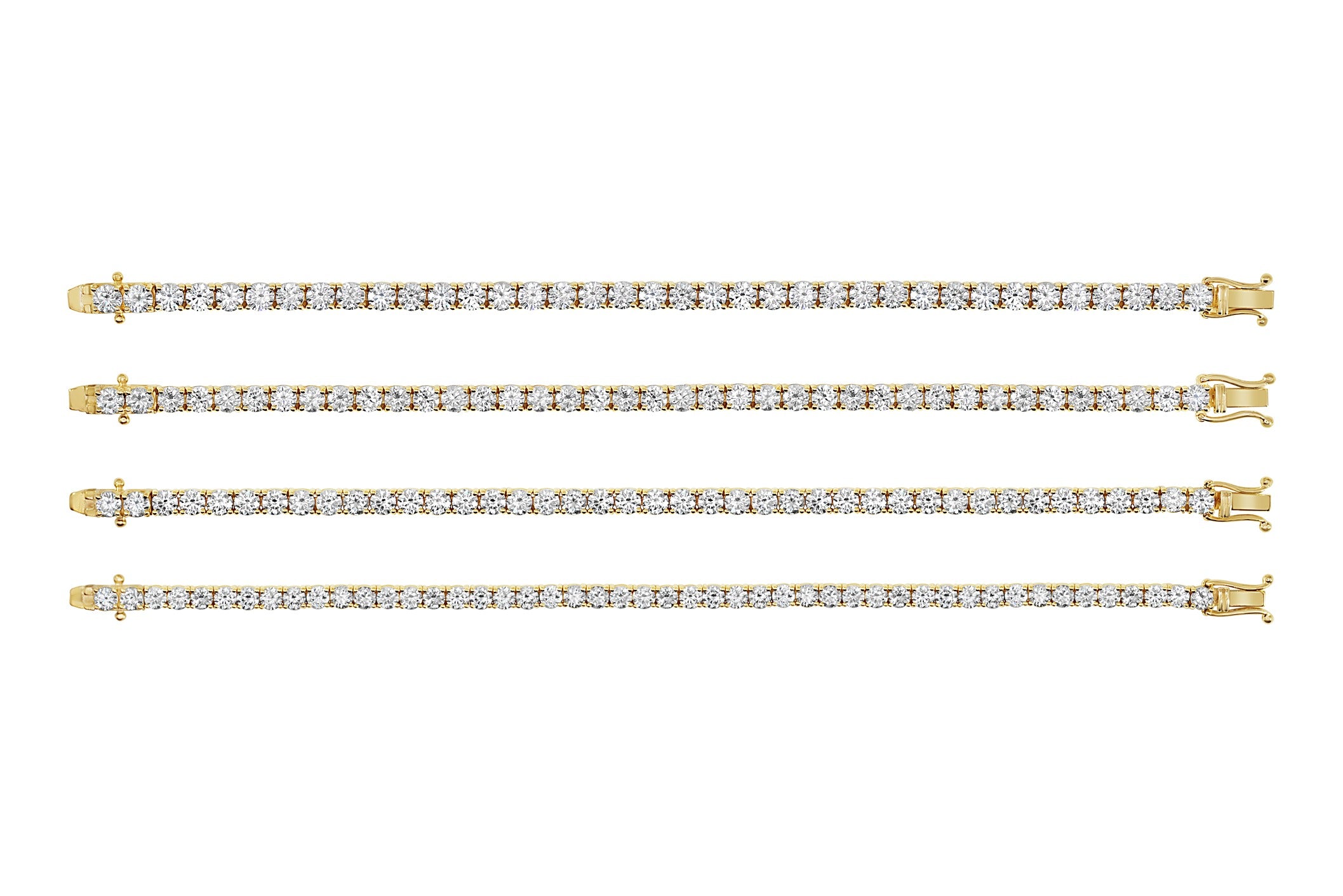 Set of four gold diamond tennis bracelets on a white background