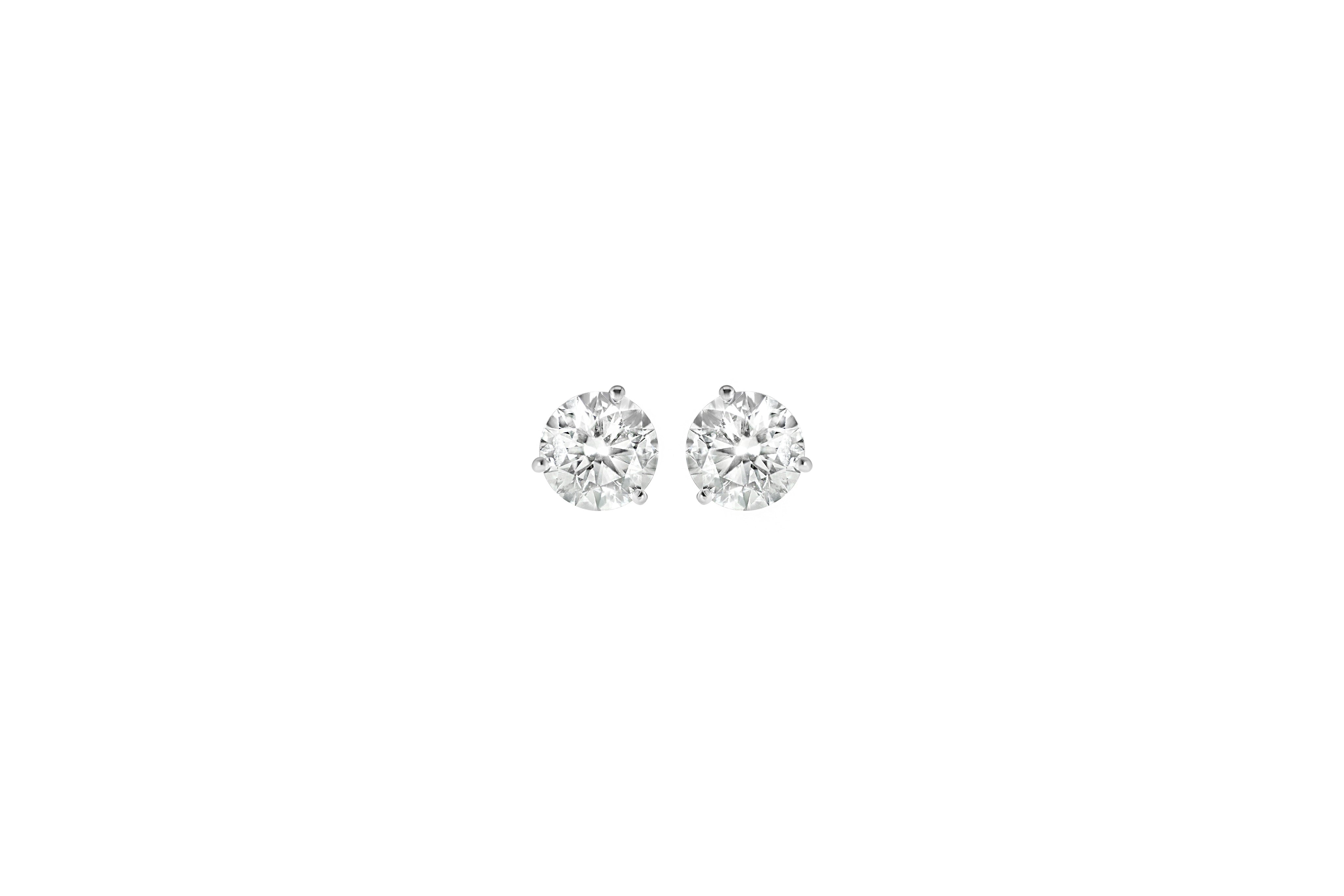 Pair of diamond stud earrings on a white background