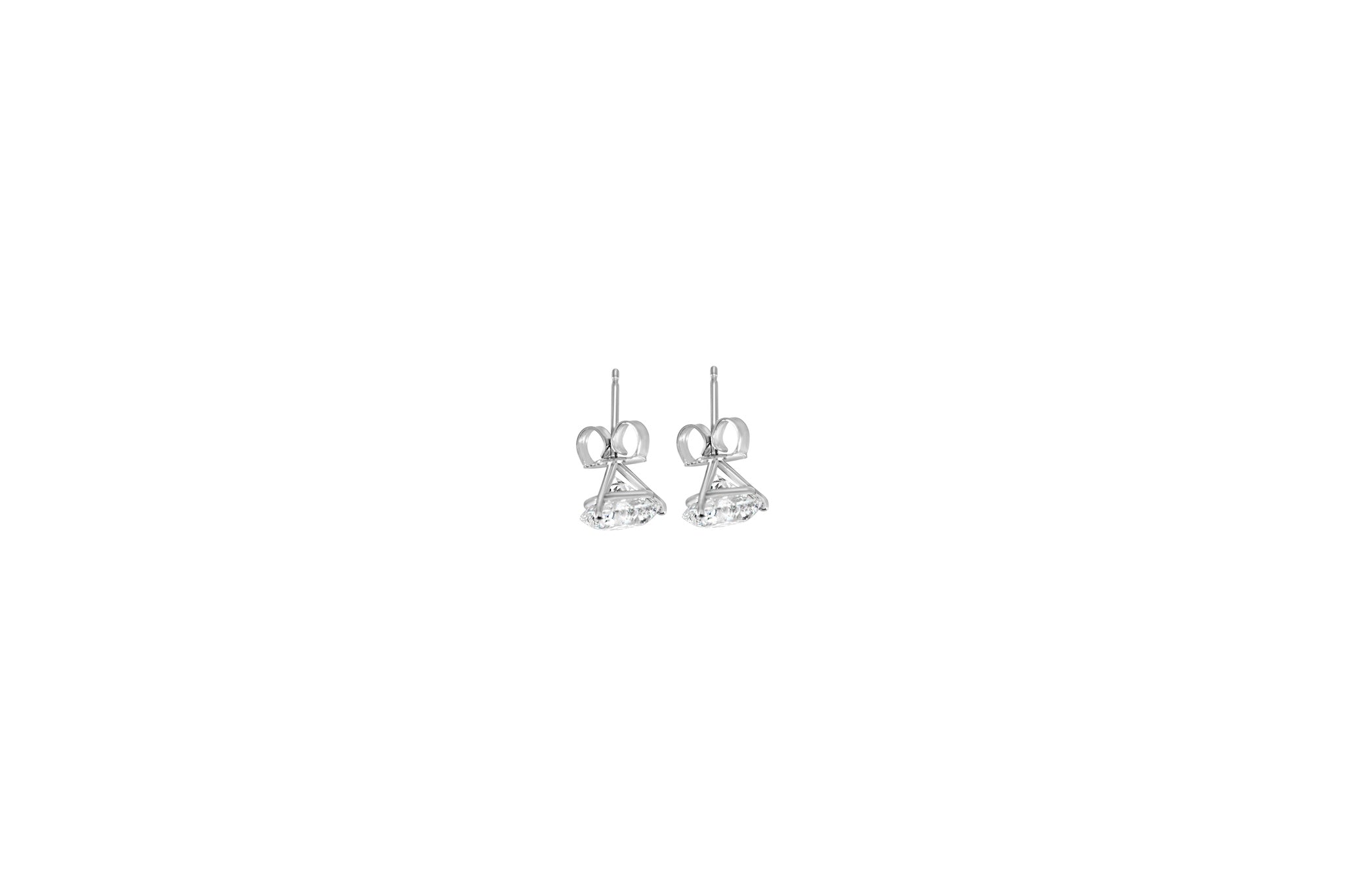Pair of white gold earrings on a white background