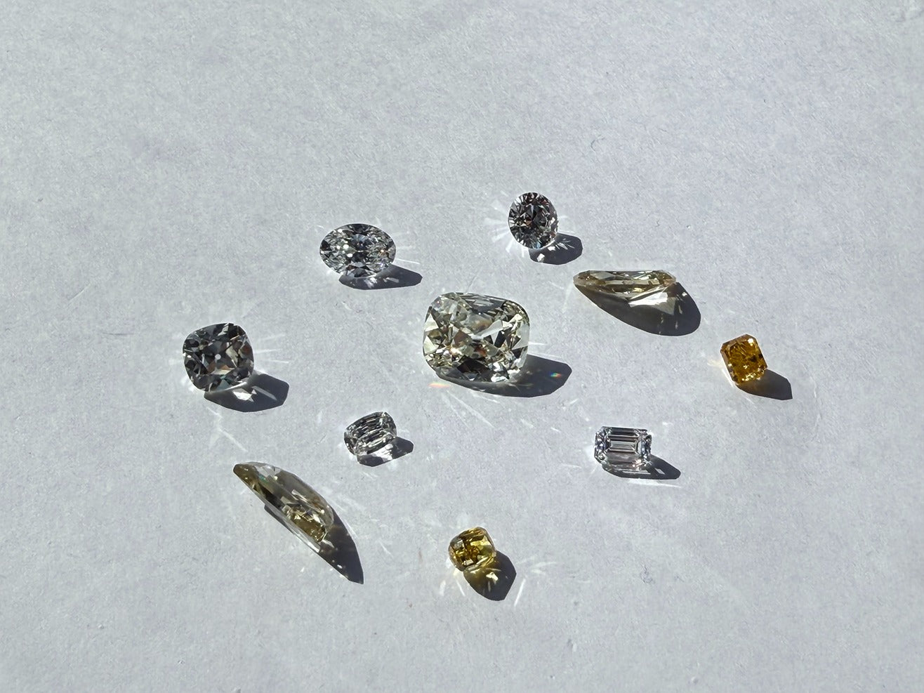 Collection of natural diamonds on a light gray background