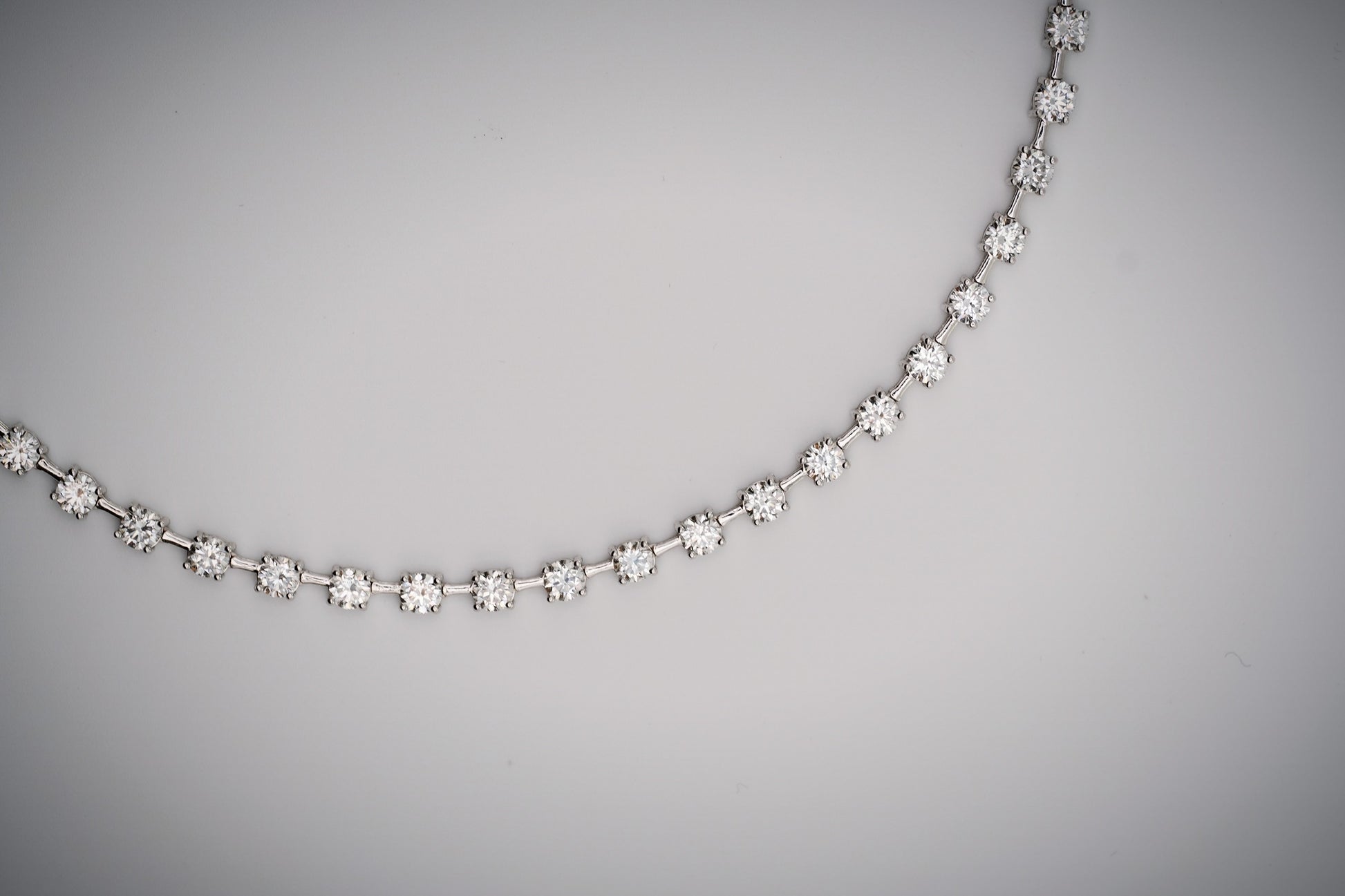 Diamond tennis necklace with space bar on a white background