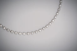 Diamond tennis necklace with space bar on a white background