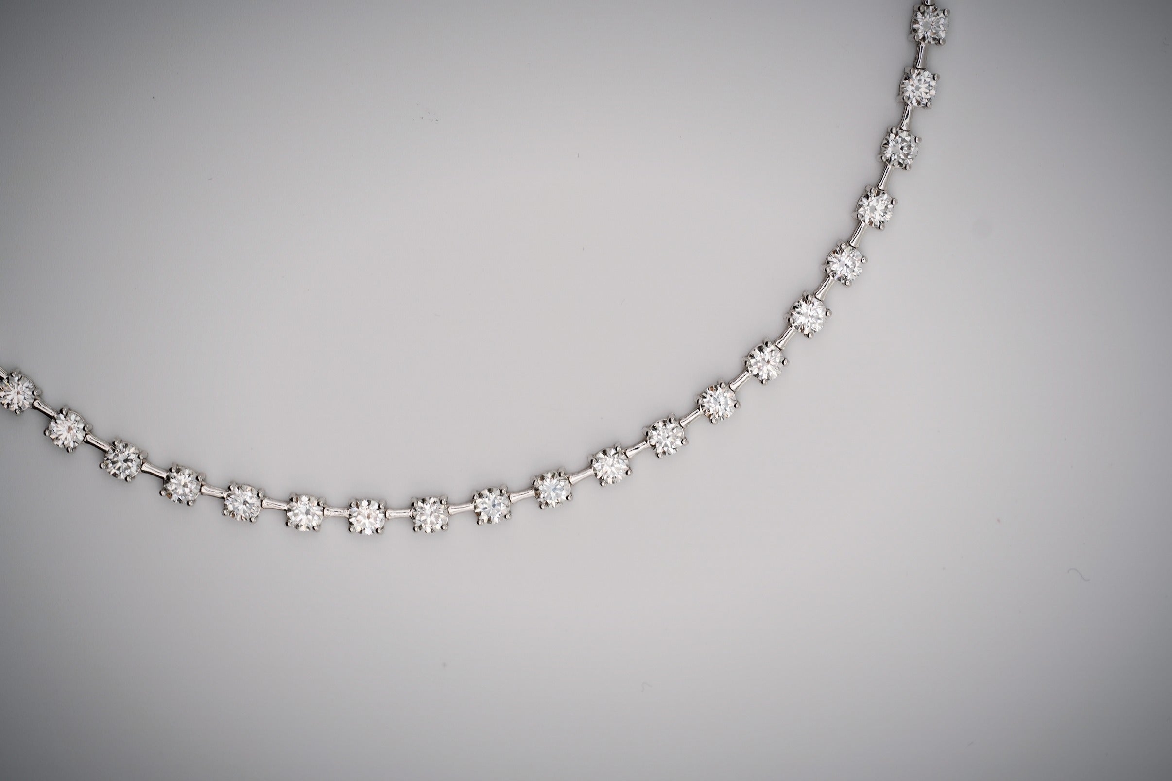 Diamond tennis necklace with space bar on a white background