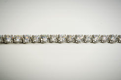 White gold diamond tennis bracelet on a grey background